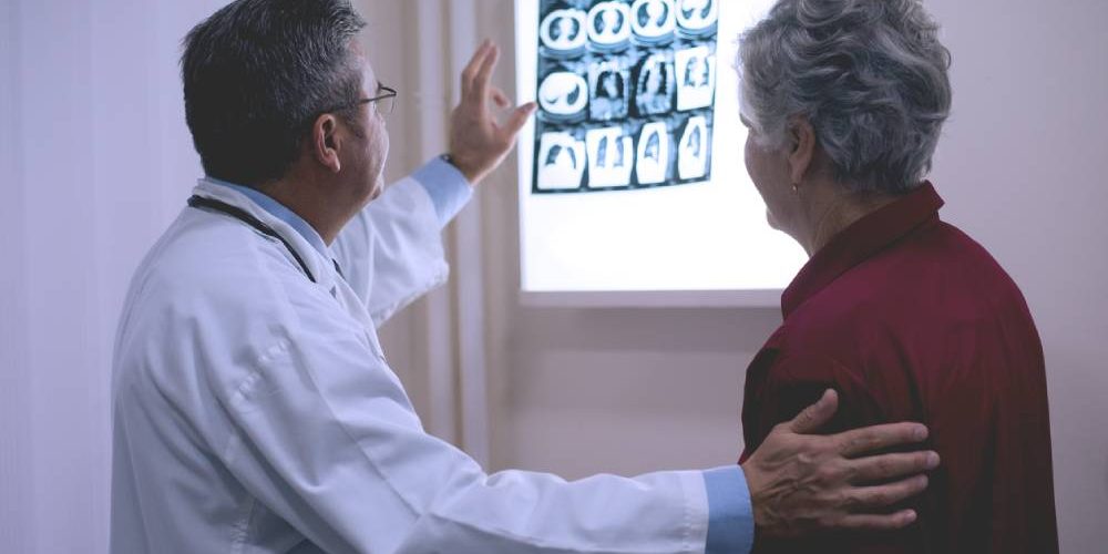 doctor showing patient x-rays